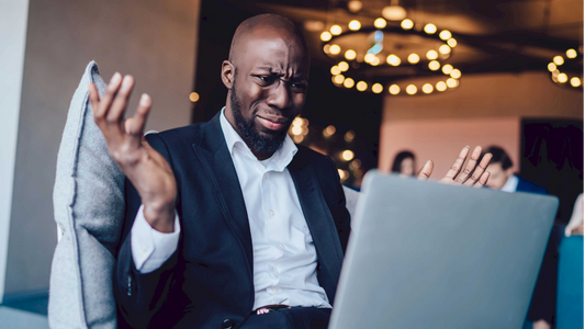 A perplexed man throws his hands in the air in exasperation, representing the baffling lack of common sense that inspires memorable fictional characters