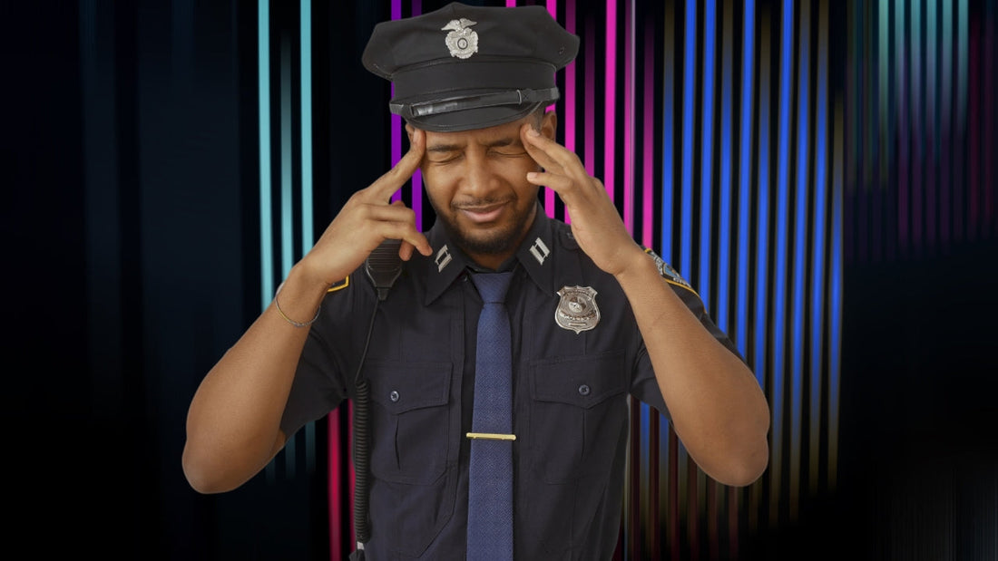 A male cop in uniform pressing his fingers to his head and shaking it in disbelief at yet another unrealistic police procedure in fiction
