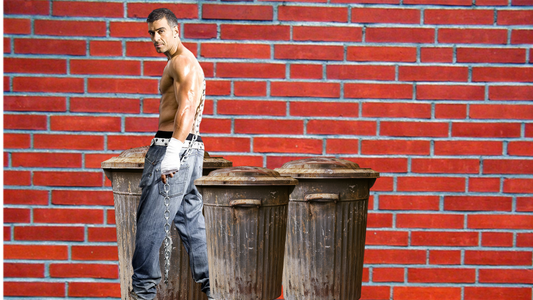 A menacing gang member glancing over his shoulder, representing the real-world threat that makes backup essential — not optional — in authentic police fiction