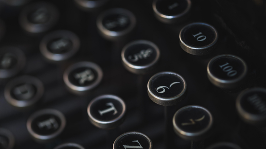 An old-fashioned typewriter keyboard in darkness, symbolizing the immersive and sometimes uncertain process of writing into the dark