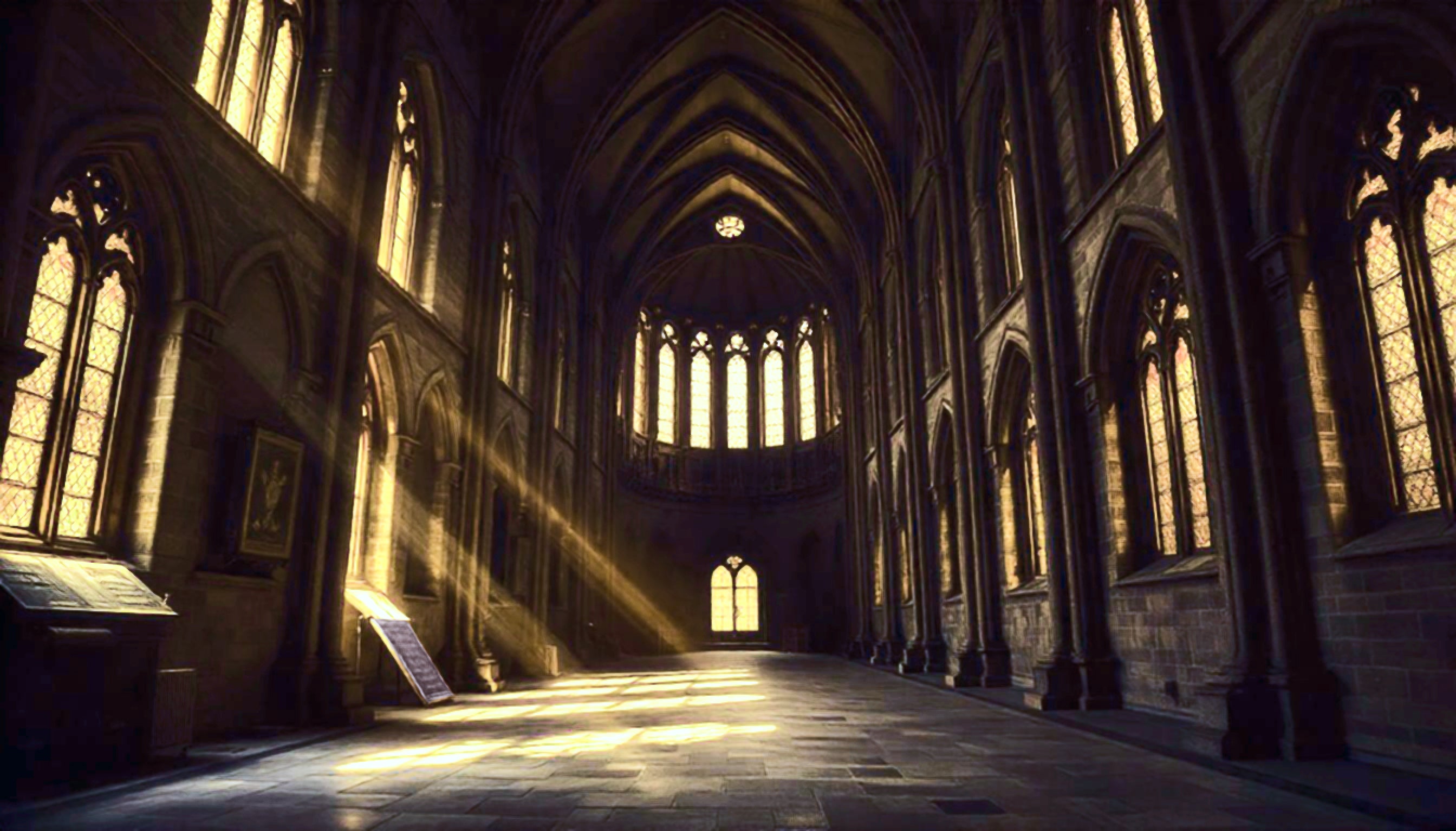 Interior of a cathedral with yellow light shining in through the windows